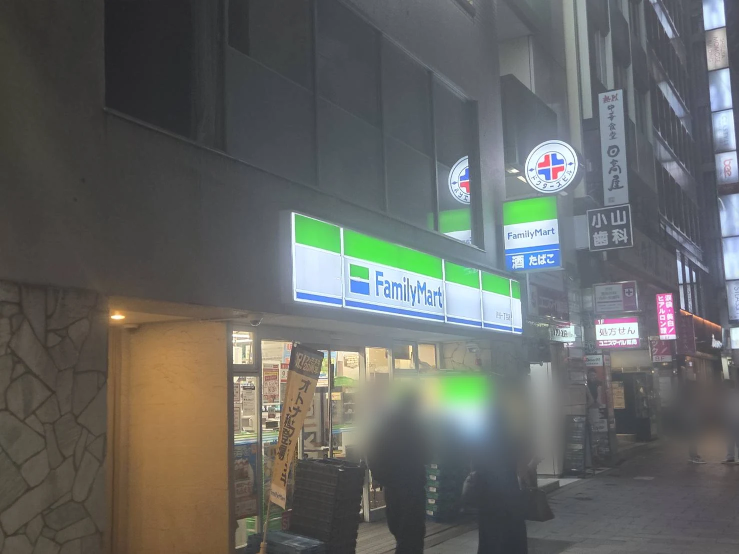 Convenience store lit up on a Tokyo street late at night