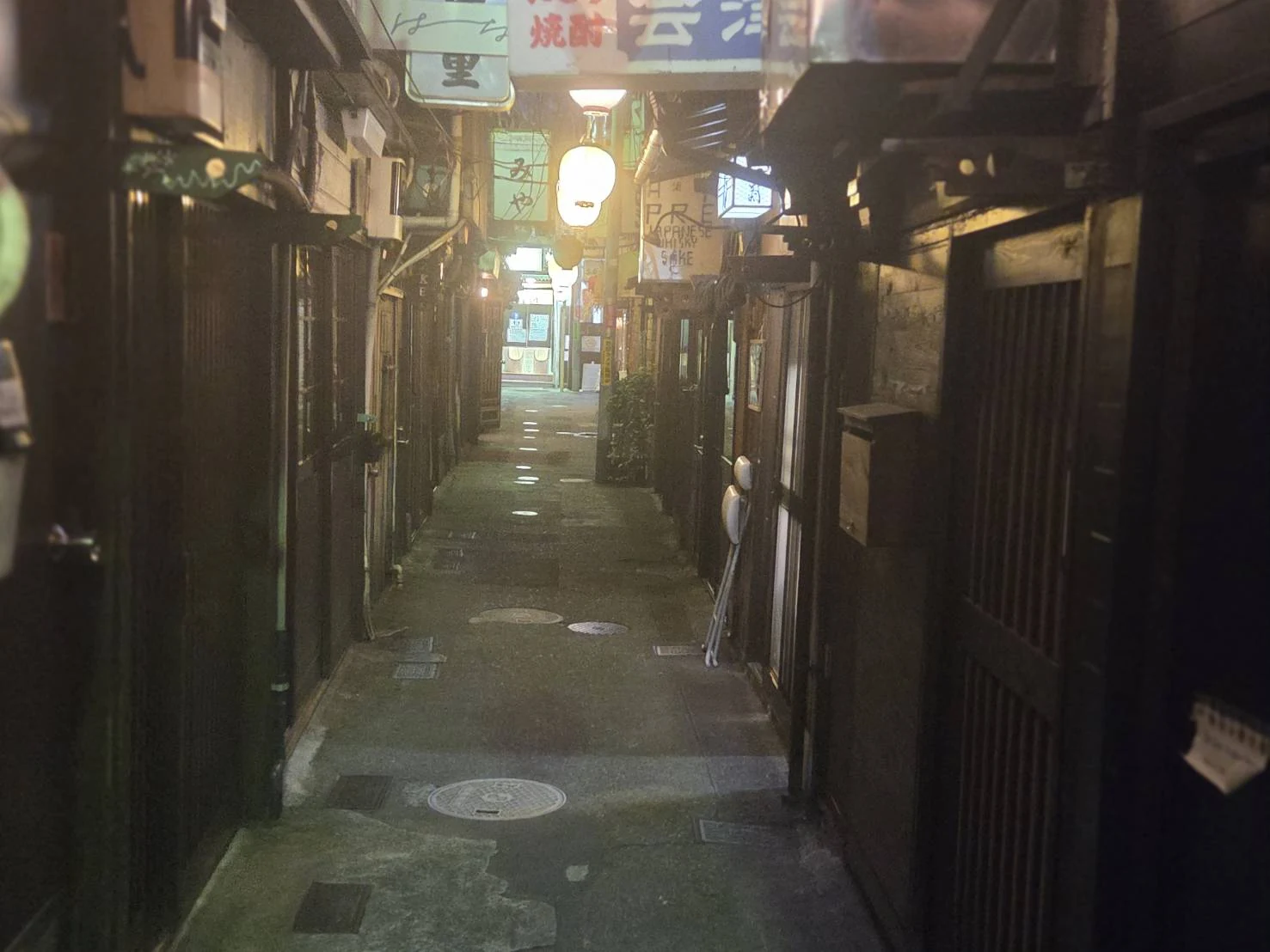 Narrow alley of small bars in Nonbei Yokocho, Shibuya, at night