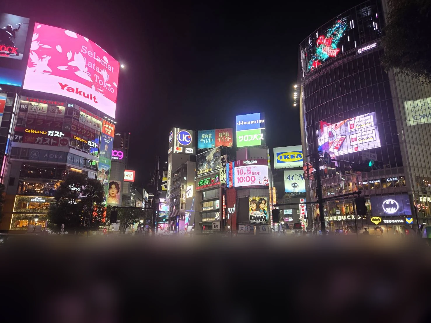 Shibuya scramble crossing and its surrounding neon at night