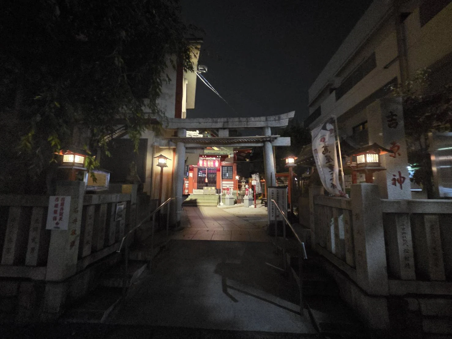 The torii and stone lanterns of Yoshiwara Shrine in Senzoku, Taito, at night
